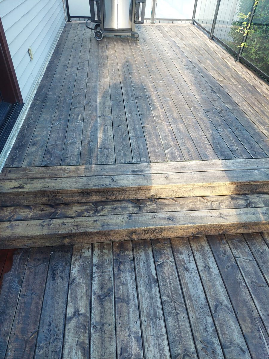 Weathered grey deck boards before staining